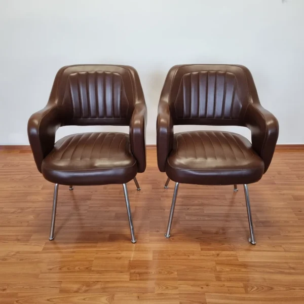 1 of 2 Mid Century office chairs in broun faux leather. Made in Italy in the 70s. In verry good condition. The price is for 1 chair